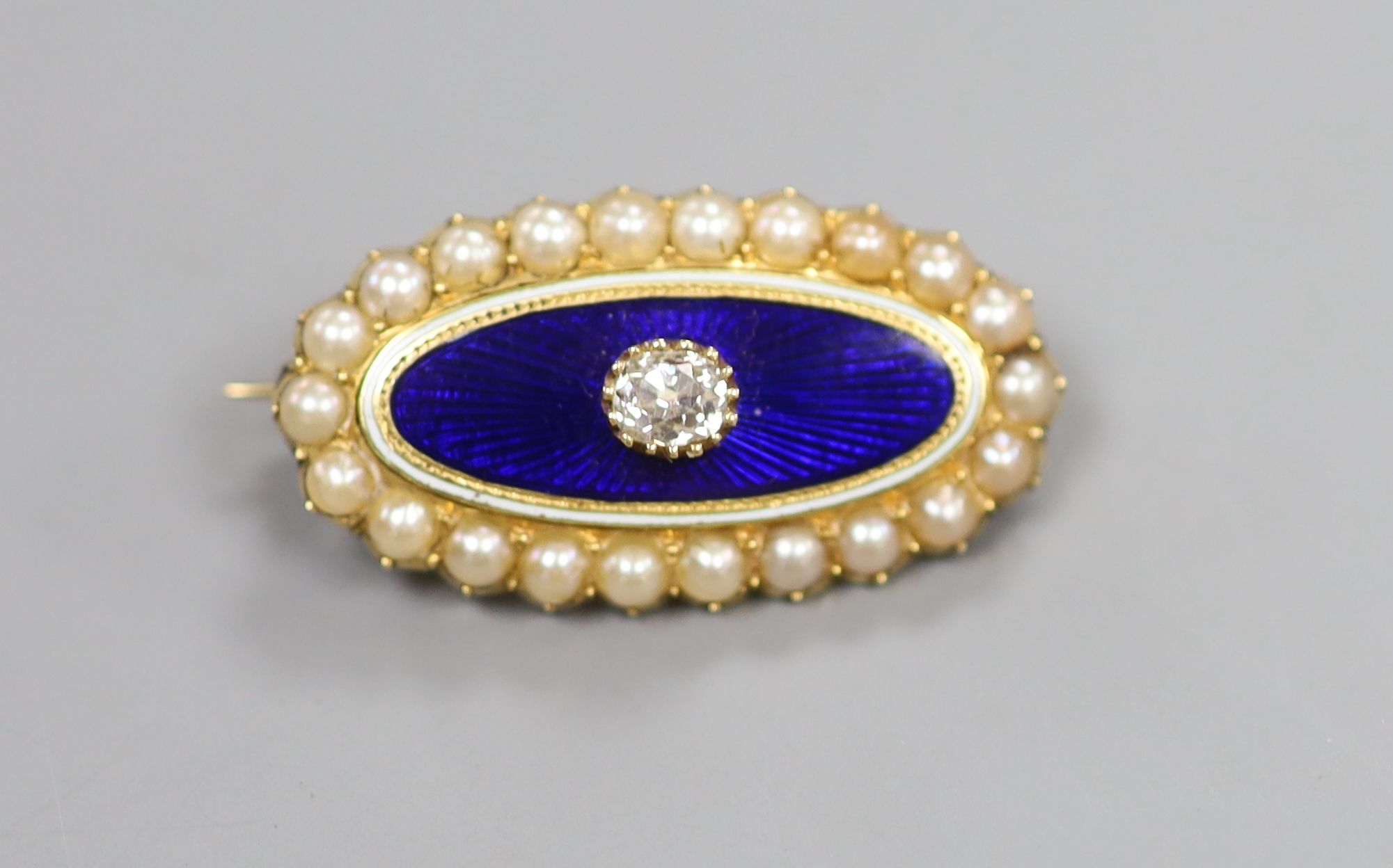 A Victorian yellow metal, blue enamel, seed pearl and diamond set oval brooch, 29mm, gross 6.8 grams,